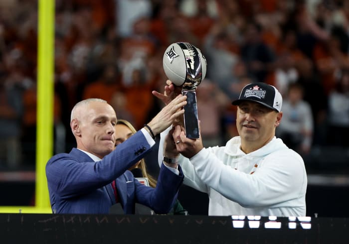 Big 12 commissioner Brett Yormark hands teh Big 12 championship to Texas Longhorns head coach Steve Sarkisian after the win against the Oklahoma State Cowboys at AT&T Stadium.